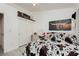 Bedroom showcasing decor, a vanity area with lighted mirror, and a closet with sliding doors at 504 Painted Cloud Pl, Las Vegas, NV 89144