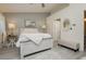 This bedroom features a king bed with decorative lamps, an accent wall, and light, wood-look flooring at 504 Painted Cloud Pl, Las Vegas, NV 89144