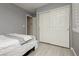 Bedroom with light gray walls, a closet with sliding doors, and white trim, next to bedroom door at 504 Painted Cloud Pl, Las Vegas, NV 89144