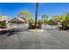 Gated community entrance with meticulously maintained landscaping and mature trees at 504 Painted Cloud Pl, Las Vegas, NV 89144