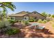 Inviting home featuring mature desert landscaping, a concrete patio set, and a well-maintained stucco exterior at 504 Painted Cloud Pl, Las Vegas, NV 89144