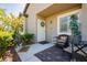 Charming front porch with stylish seating area, decorative wreath and mature landscaping at 504 Painted Cloud Pl, Las Vegas, NV 89144