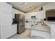 Modern kitchen boasting stainless steel appliances, granite countertops, and ample storage space in white cabinetry at 504 Painted Cloud Pl, Las Vegas, NV 89144