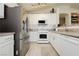 Well-lit kitchen showcasing stainless steel appliances, white cabinets, and granite countertops, creating a functional space at 504 Painted Cloud Pl, Las Vegas, NV 89144