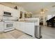 Clean kitchen featuring white appliances, white cabinets and stylish countertops with access to the open floor plan at 504 Painted Cloud Pl, Las Vegas, NV 89144