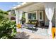 Charming covered patio featuring cozy seating, elegant curtains, and a peaceful outdoor retreat at 504 Painted Cloud Pl, Las Vegas, NV 89144