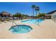 Inviting community pool and spa area with palm trees and lounge chairs at 504 Painted Cloud Pl, Las Vegas, NV 89144