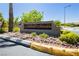 Beautiful 'Sunset Mesa' sign surrounded by lush landscaping on a sunny day at 504 Painted Cloud Pl, Las Vegas, NV 89144