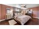 Comfortable bedroom features a ceiling fan, carpet, and great natural light at 506 Chestnut View Pl, Henderson, NV 89052