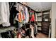 Walk-in closet with custom shelving, hanging rods, and dark wood flooring provides ample storage at 506 Chestnut View Pl, Henderson, NV 89052