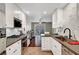 Modern kitchen featuring stainless steel appliances, stone countertops, and seamless flow to dining at 506 Chestnut View Pl, Henderson, NV 89052
