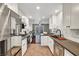Modern eat-in kitchen featuring stainless steel appliances, ample storage, and stone countertops at 506 Chestnut View Pl, Henderson, NV 89052