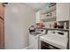Well-equipped laundry room boasting modern washer and dryer with overhead storage shelves at 506 Chestnut View Pl, Henderson, NV 89052