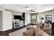 Spacious living room features a fan, hardwood floors, plush rug, comfortable seating, and bright natural light at 506 Chestnut View Pl, Henderson, NV 89052