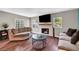 Comfortable living room with a fireplace, hardwood floors, and plenty of natural light, perfect for relaxing at 506 Chestnut View Pl, Henderson, NV 89052