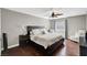 Comfortable bedroom with hardwood floors, fan, and a cozy sitting area, is perfect for relaxation at 506 Chestnut View Pl, Henderson, NV 89052