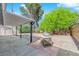 Backyard with covered patio, stone accents, outdoor grill, and mature landscaping offers an inviting outdoor space at 5162 Somerset Dr, Las Vegas, NV 89120