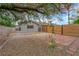 Landscaped backyard with brick patio, stone ground cover, mature trees, and partial fencing at 5162 Somerset Dr, Las Vegas, NV 89120
