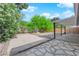 Spacious backyard with sand volleyball court, covered patio, stone accents, and mature foliage at 5162 Somerset Dr, Las Vegas, NV 89120