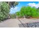 Large backyard with sand volleyball court, decorative plants, and a peaceful water fountain feature at 5162 Somerset Dr, Las Vegas, NV 89120