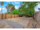 Backyard featuring trees, gravel, a brick patio, and a new wood fence at 5162 Somerset Dr, Las Vegas, NV 89120