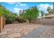 A spacious backyard featuring decorative rock ground cover, a tree, and privacy fencing at 5162 Somerset Dr, Las Vegas, NV 89120