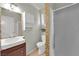 Traditional bathroom with white sink and cabinet, mosaic tile accent wall, and enclosed shower at 5162 Somerset Dr, Las Vegas, NV 89120