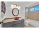 Bathroom featuring elegant vanity with a vessel sink, decorative mirror, and tiled shower-tub combo at 5162 Somerset Dr, Las Vegas, NV 89120