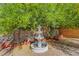 Tiered water fountain in landscaped backyard with mature shade tree offering a relaxing outdoor retreat at 5162 Somerset Dr, Las Vegas, NV 89120