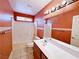 Bathroom featuring orange walls, a vanity and a shower-tub combination at 5704 Burdel St, Las Vegas, NV 89149