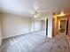 A neutral-toned bedroom featuring carpeted floors, ceiling fan and mirrored closet doors at 5704 Burdel St, Las Vegas, NV 89149