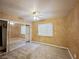 A carpeted bedroom featuring mirrored closet doors and a ceiling fan at 5704 Burdel St, Las Vegas, NV 89149