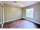 An airy bedroom with tile floors, a ceiling fan, and a large window at 5704 Burdel St, Las Vegas, NV 89149