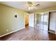 Bedroom features a ceiling fan, wood-look tile flooring, and a closet with mirrored doors at 5704 Burdel St, Las Vegas, NV 89149