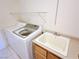 Practical laundry area features a washer, utility sink and storage shelves at 5704 Burdel St, Las Vegas, NV 89149