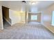 Open-concept living room leading to tiled entryway, stairs and well-lit interior at 5704 Burdel St, Las Vegas, NV 89149