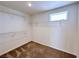 A simple walk-in closet with adjustable shelving and a small window at 5704 Burdel St, Las Vegas, NV 89149