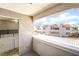 Balcony features a laundry closet and a view of the community's architecture and landscaping at 611 Bass Dr # C, Henderson, NV 89014