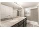 Bathroom features granite countertops, double sinks, and a glass-enclosed shower at 611 Bass Dr # C, Henderson, NV 89014