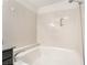 Close-up of soaking tub with tile surround and shower fixtures at 611 Bass Dr # C, Henderson, NV 89014