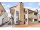 Exterior view of apartment building with tan chimney feature and red-tiled roof at 611 Bass Dr # C, Henderson, NV 89014