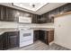 Modern kitchen features granite countertops, white appliances, and wood cabinets at 611 Bass Dr # C, Henderson, NV 89014