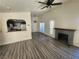 Bright living room with fireplace, modern ceiling fan, and doorway to backyard at 611 Bass Dr # C, Henderson, NV 89014