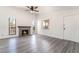 Bright living room featuring a brick fireplace, modern flooring and natural light at 611 Bass Dr # C, Henderson, NV 89014