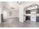 Open living room features luxury vinyl floors, a ceiling fan, and a fireplace at 611 Bass Dr # C, Henderson, NV 89014