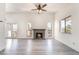 Open concept living room featuring a cozy brick fireplace and bright windows at 611 Bass Dr # C, Henderson, NV 89014
