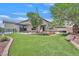 Inviting back yard with lush artificial turf and a built-in fire pit at 6150 Bunker Commons Ct, Las Vegas, NV 89108