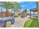 Serene backyard featuring a hot tub, stone pavers, grass, and a pergola-covered patio at 6150 Bunker Commons Ct, Las Vegas, NV 89108