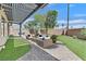 Stylized backyard patio area featuring stone pavers, outdoor furniture, and manicured landscape at 6150 Bunker Commons Ct, Las Vegas, NV 89108
