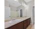 A primary bathroom featuring dual sinks, a large mirror, and a shower/tub combo at 6150 Bunker Commons Ct, Las Vegas, NV 89108